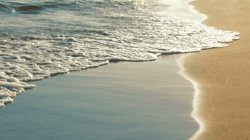 Soft Sea Waves Rushing On Sandy Beach On Sunset