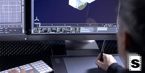 Graphic Designer Working on Digital Tablet at Desk
