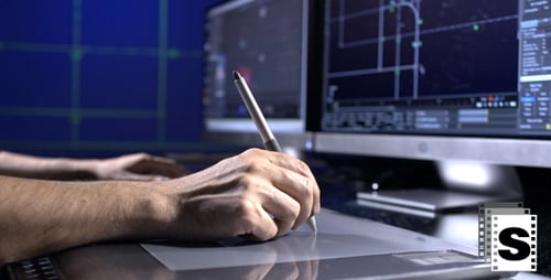 Designer Using Stylus on Digital Tablet in Office