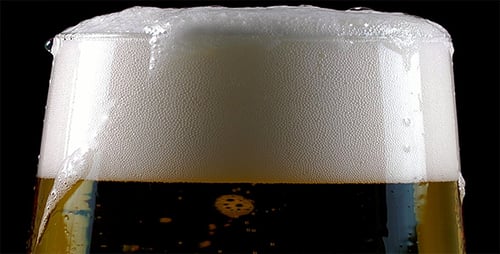 Frothy Beer in Glass Close Up