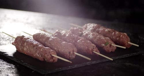 Raw Sausages From Homemade Mince on a Stone Board Rotate.