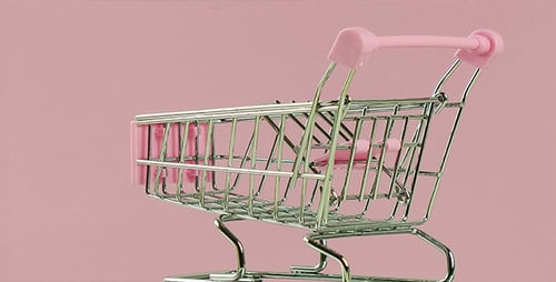 Miniature Pink Shopping Cart on Pink Background