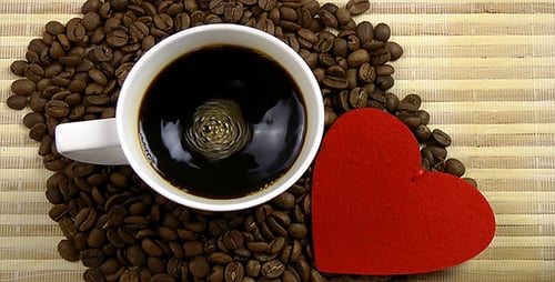 Hot Coffee with Heart Symbol and Roasted Beans