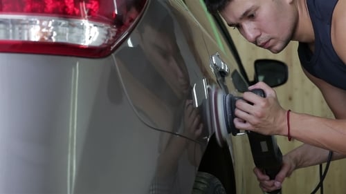 Man Polishing Car with Power Buffer