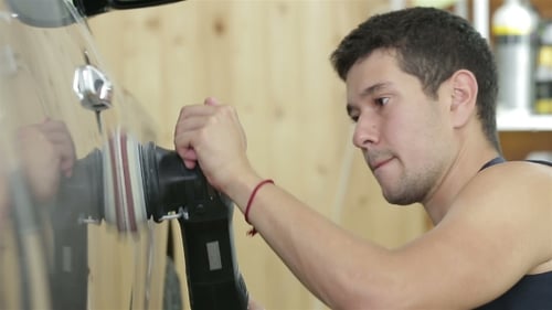 Young Man Polishing Car with Power Tool