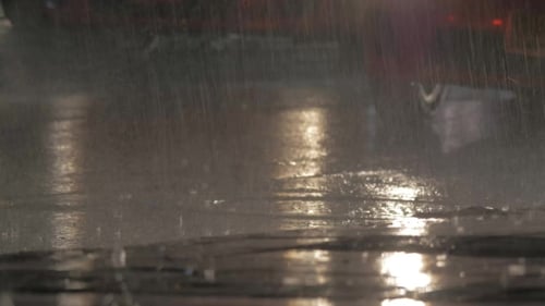 Cars Driving Under The Rain At Night