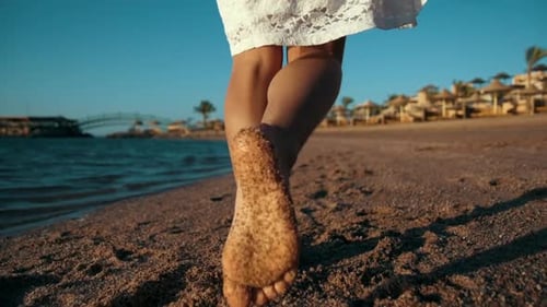 Woman Bare Legs Walking on Beach Sand