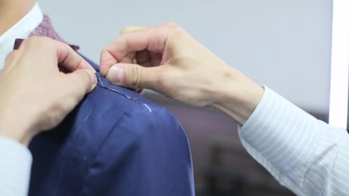 Tailor Takes Measurements From The Man's Jacket