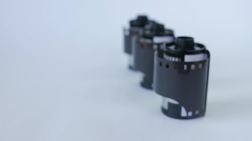 Old 35 Mm Film In Cartridge On a White Background.