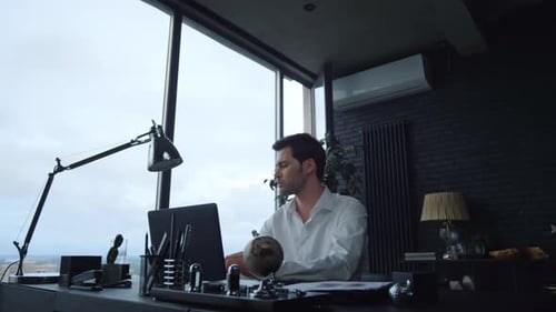 Businessman Working on Laptop Computer in Office. Worker Answering on Phone Call