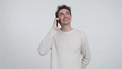 Handsome Man with Blue Eyes and Brown hair Talking on His Phone