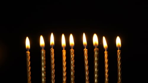 Footage Golden Burning Candles Set On Black Background.