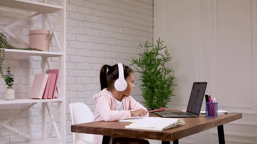 Girl Studying Online with Laptop and Headphones