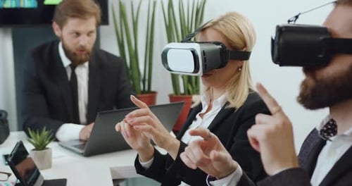 Business People Using VR Headsets in Modern Office