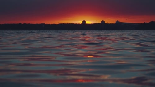Sonnenuntergang über dem Wasser. Interessantes ungewöhnliches Licht.