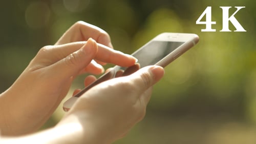 Woman Using Mobile Phone Outdoors Close Up