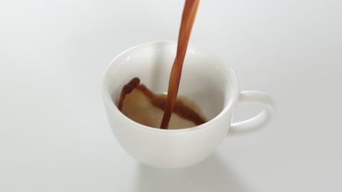 Coffee Being Poured Into a White Mug