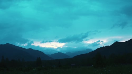 Moody Mountain Landscape at Night Under Teal Sky
