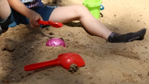 Child Playing with Sand Toys in Sunlight