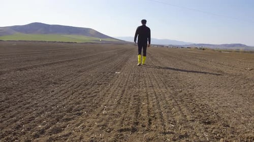 Farmer walking in the field.