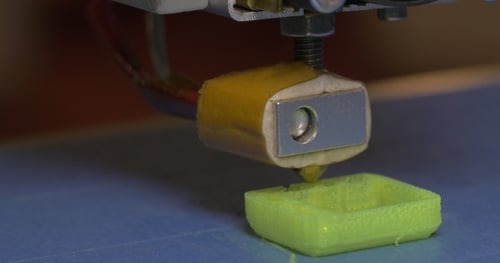 Three-Dimensional Printer Creating a Green Square Object