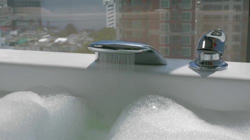 Woman Running Bath With Foam