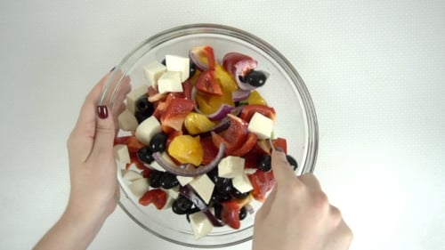 Woman Hands Mix Greek Salad