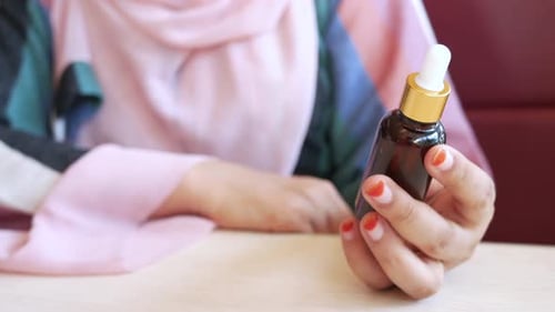 Adult Woman Holding Skin Care Dropper Bottle