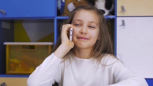 Smiling Girl Talking on the Phone at Home