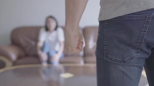 Threatening Fist with Woman in the Background