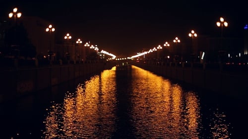 Night Canal with Shimmering City Lights