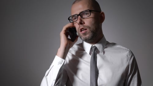 Man Talks on Cellphone Expressively in Close Up