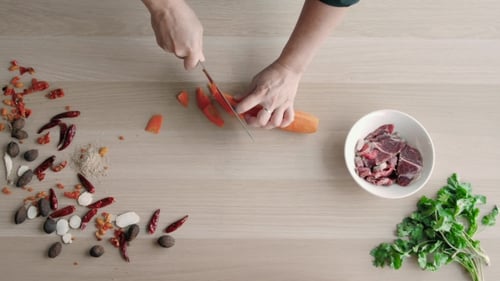 Top View Of Chefs Hands Chopping Carrot On Wooden Board, Healthy Food Concept