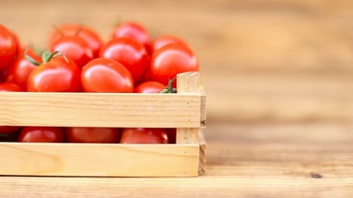 Red Tomatoes in Wooden Crate with Green Vegetables
