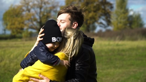 Young Family In The Park.