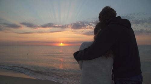 Loving Couple Embracing on Beach at Sunset
