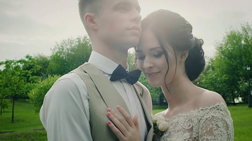 Loving Couple Embrace on Wedding Day in Park