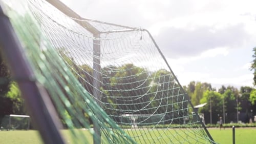 Ball Flying Into Football Goal Net On Field