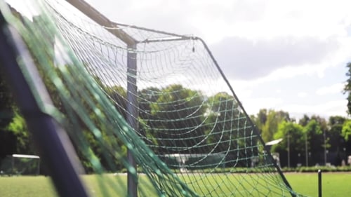 Ball Flying Into Football Goal Net On Field