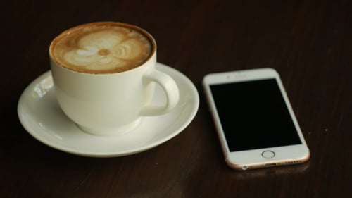Coffee and Smartphone on Table, Hand Touching Screen