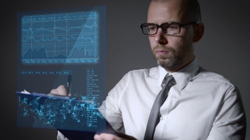 Man Analyzing Futuristic Digital Charts and Graphs