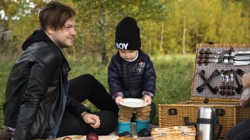 Family Picnicking In The Park.