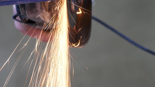 Man Sawing Metal By Grinder