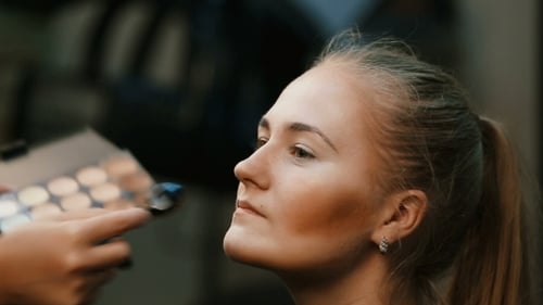 Woman Having Makeup Applied by an Artist