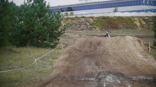 Motocross Rider Jumps on Dirt Bike