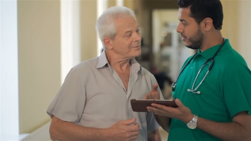 Doctor Explains Treatment Plan to Senior Patient