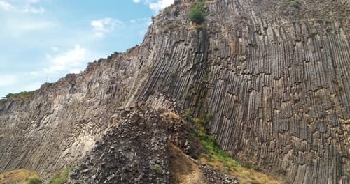 Impressive Columnar Rock Formation Under a Bright Sky