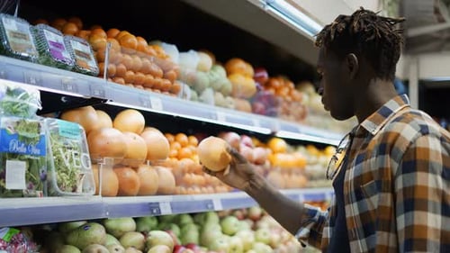 Young Adult Shopping for Fruit in Supermarket