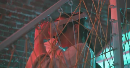 Woman Using Virtual Reality Headset in Dimly Lit Room