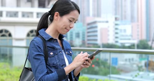 Woman use of mobile phone in city